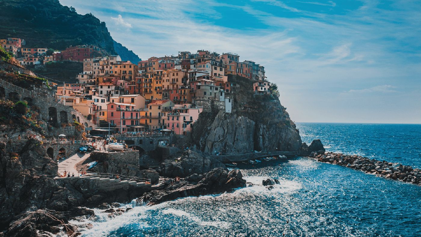 Vista panorámica de las coloridas casas de Cinque Terre, uno de los destinos más pintorescos de Italia, ideal para explorar en camper.
