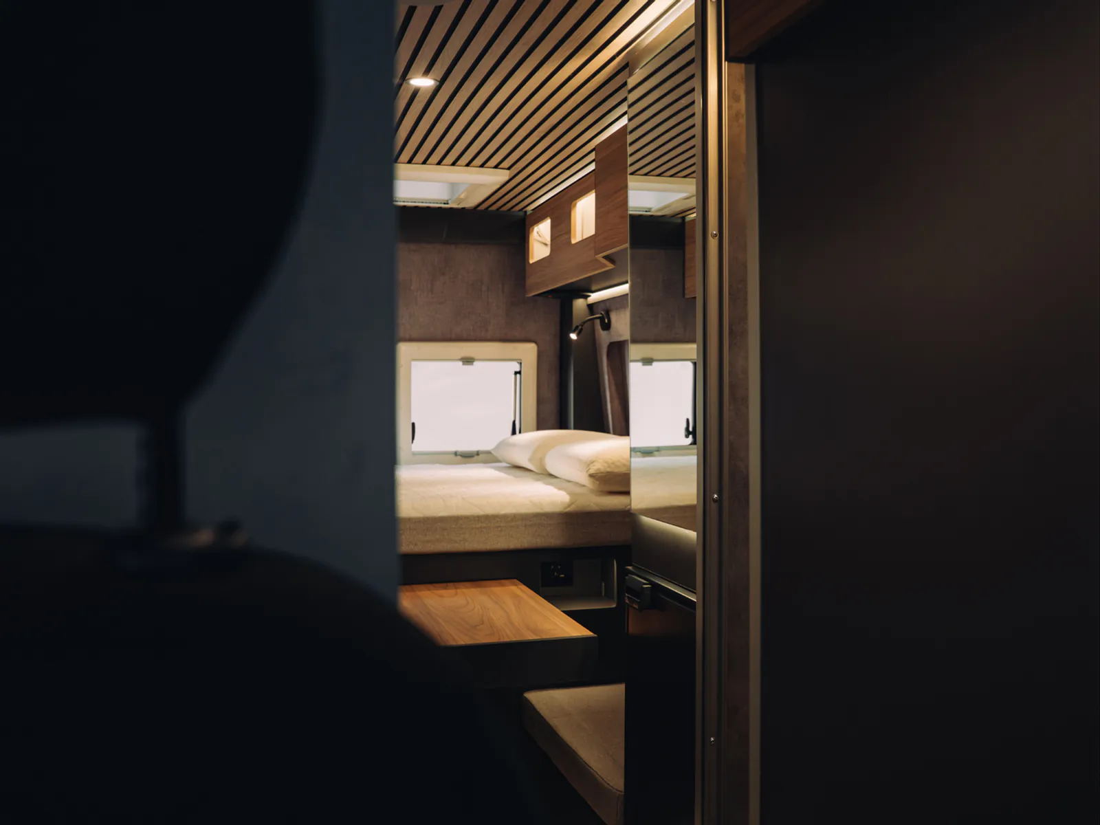 The rear double bed seen from the corridor, with the wooden table unfolded