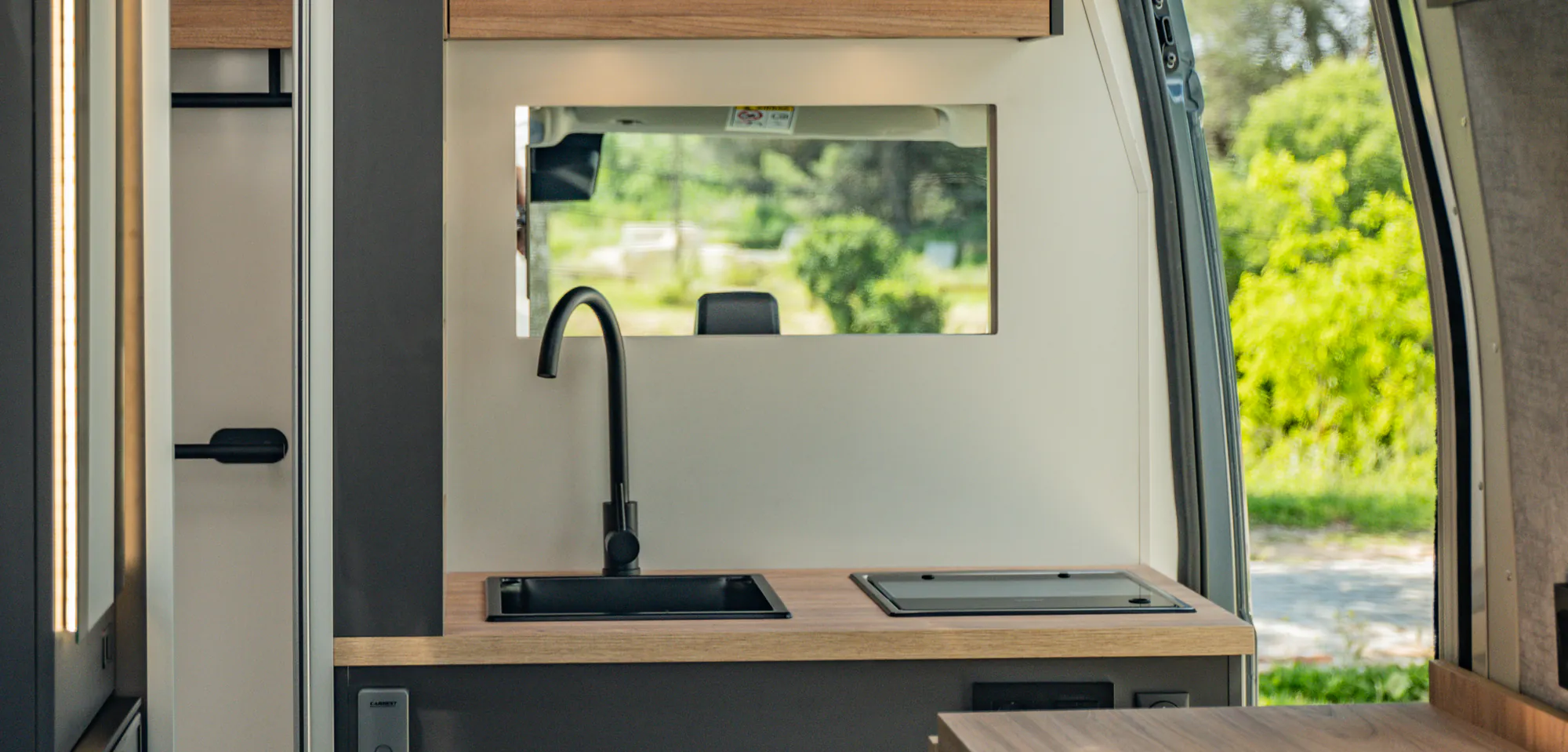 The Neo's kitchen with the window open to the landscape